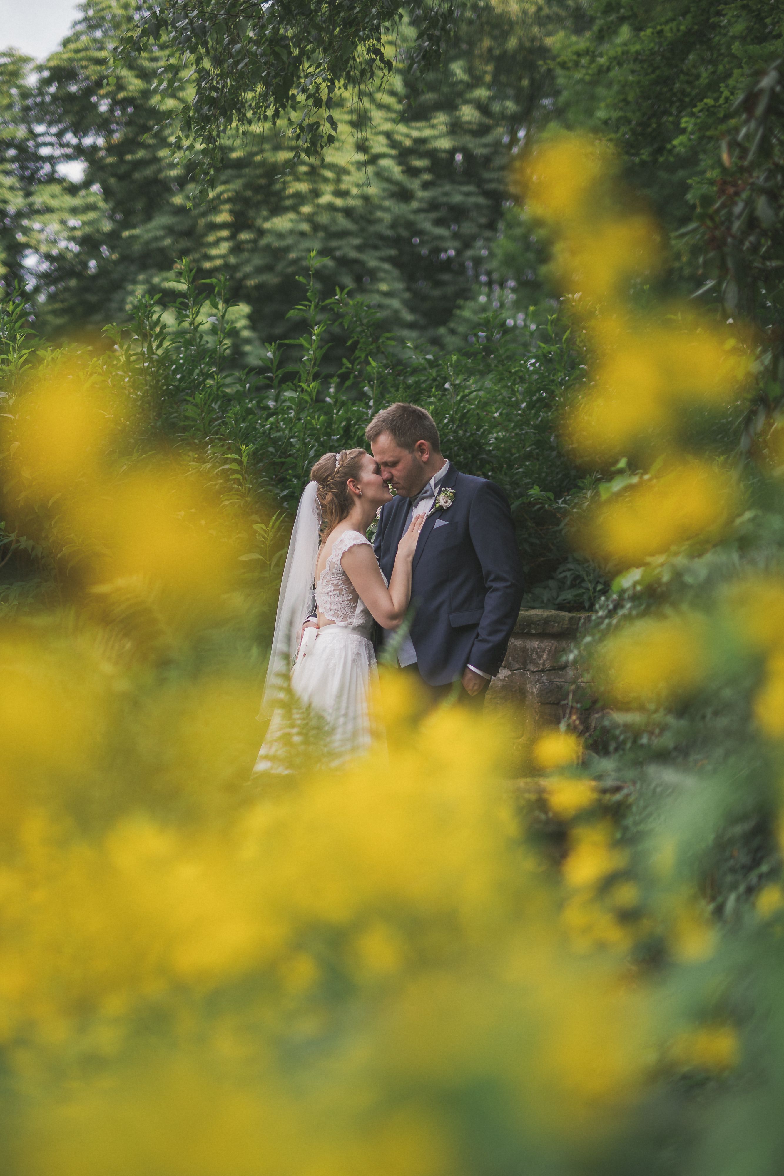 Photo of the Bride and Groom Kissing in a Garden · Free Stock Photo