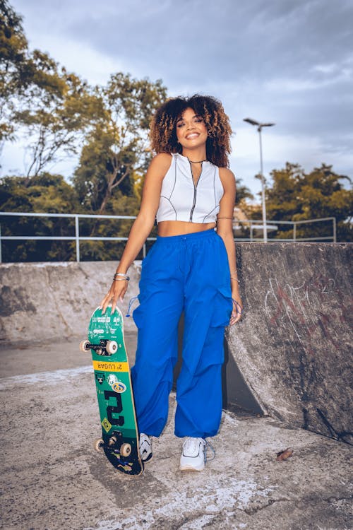 A young woman with a skateboard in her hand