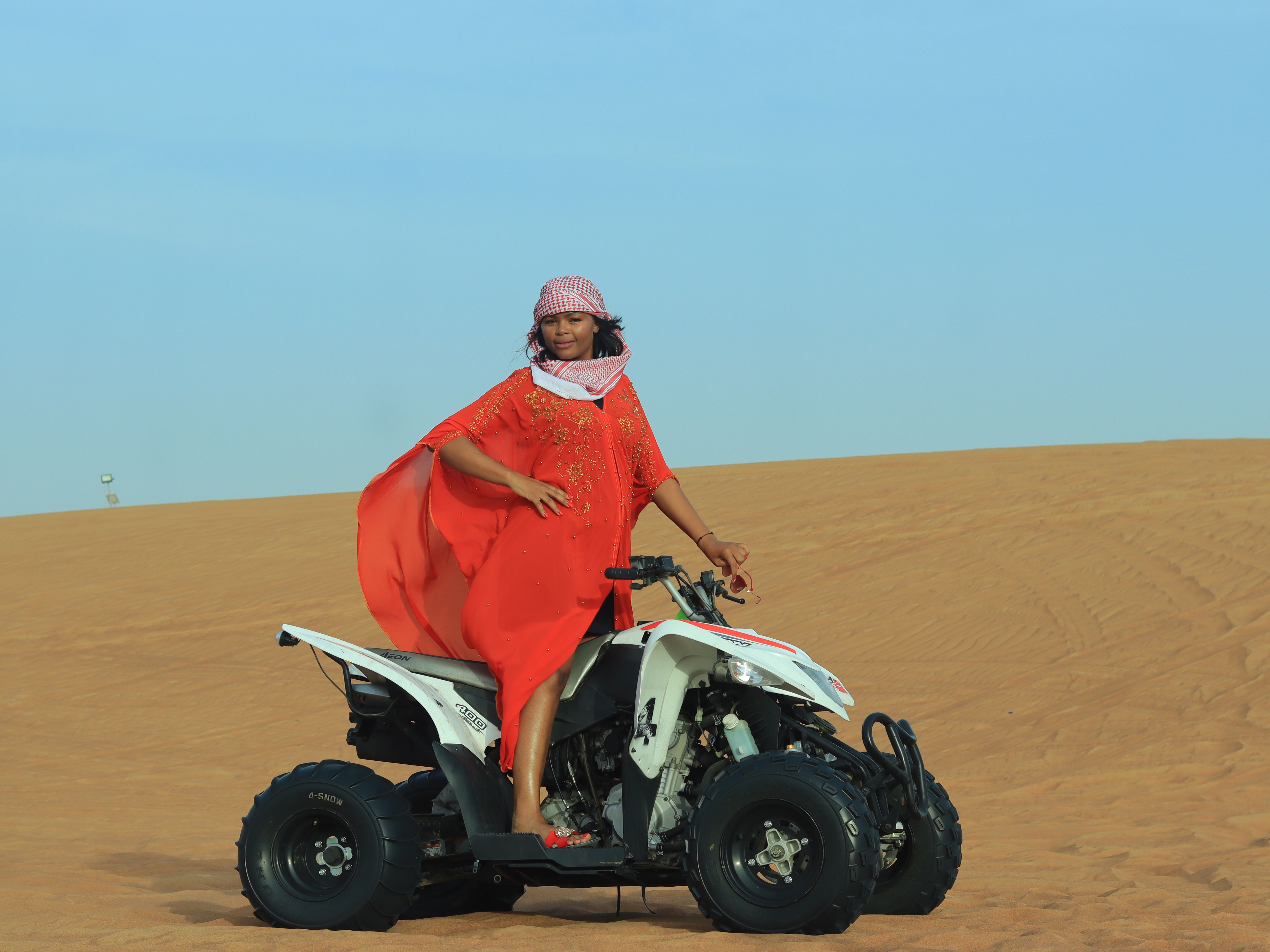 Woman in Red Dress Standing on Quad on Desert · Free Stock Photo
