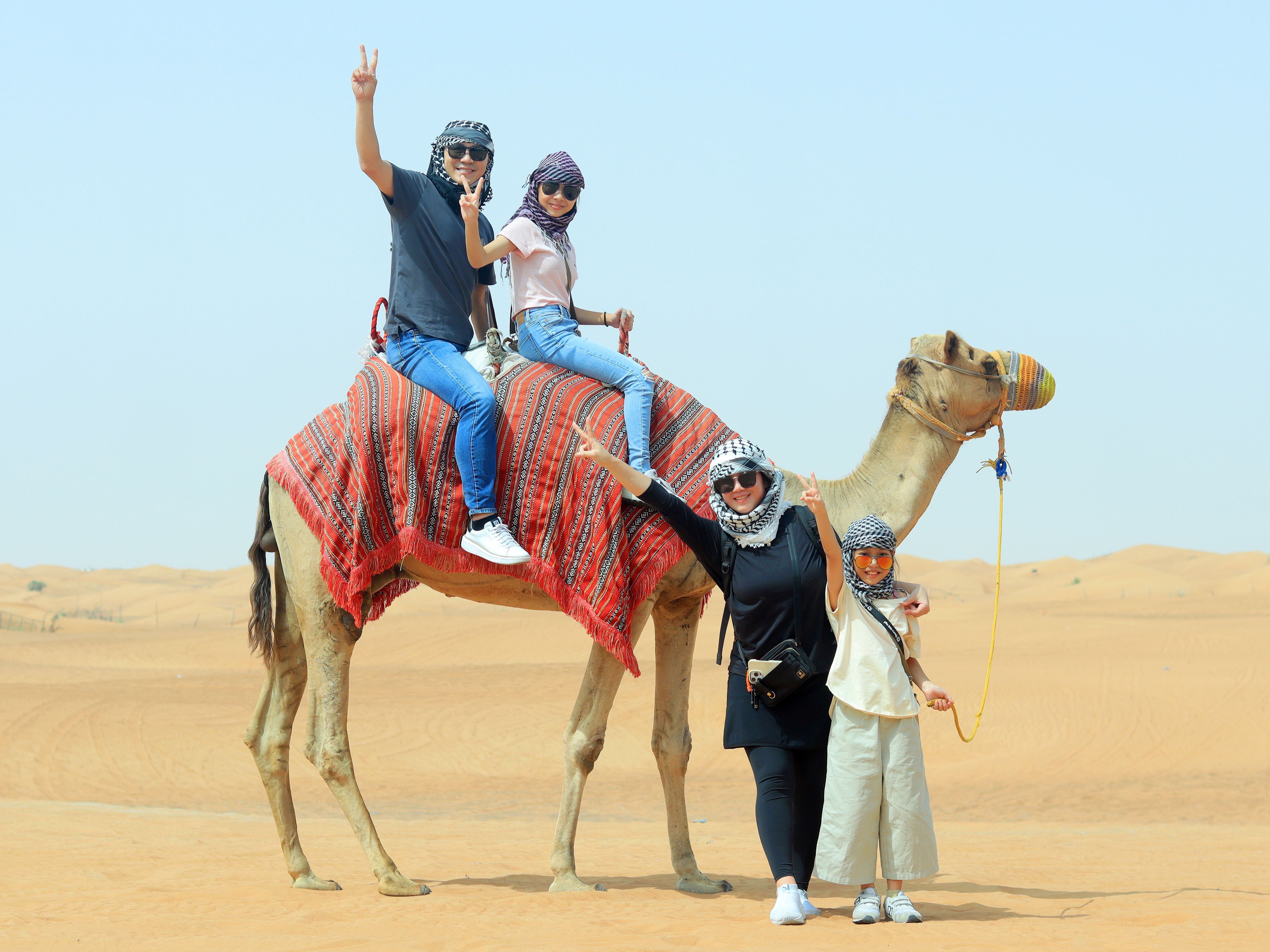 Family camel ride during a UAE desert safari