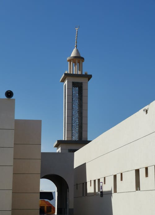 A clock tower is seen in front of a building