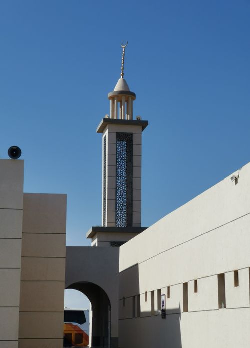 Free Vertical shot of a mosque's minaret against a clear blue sky. Stock Photo