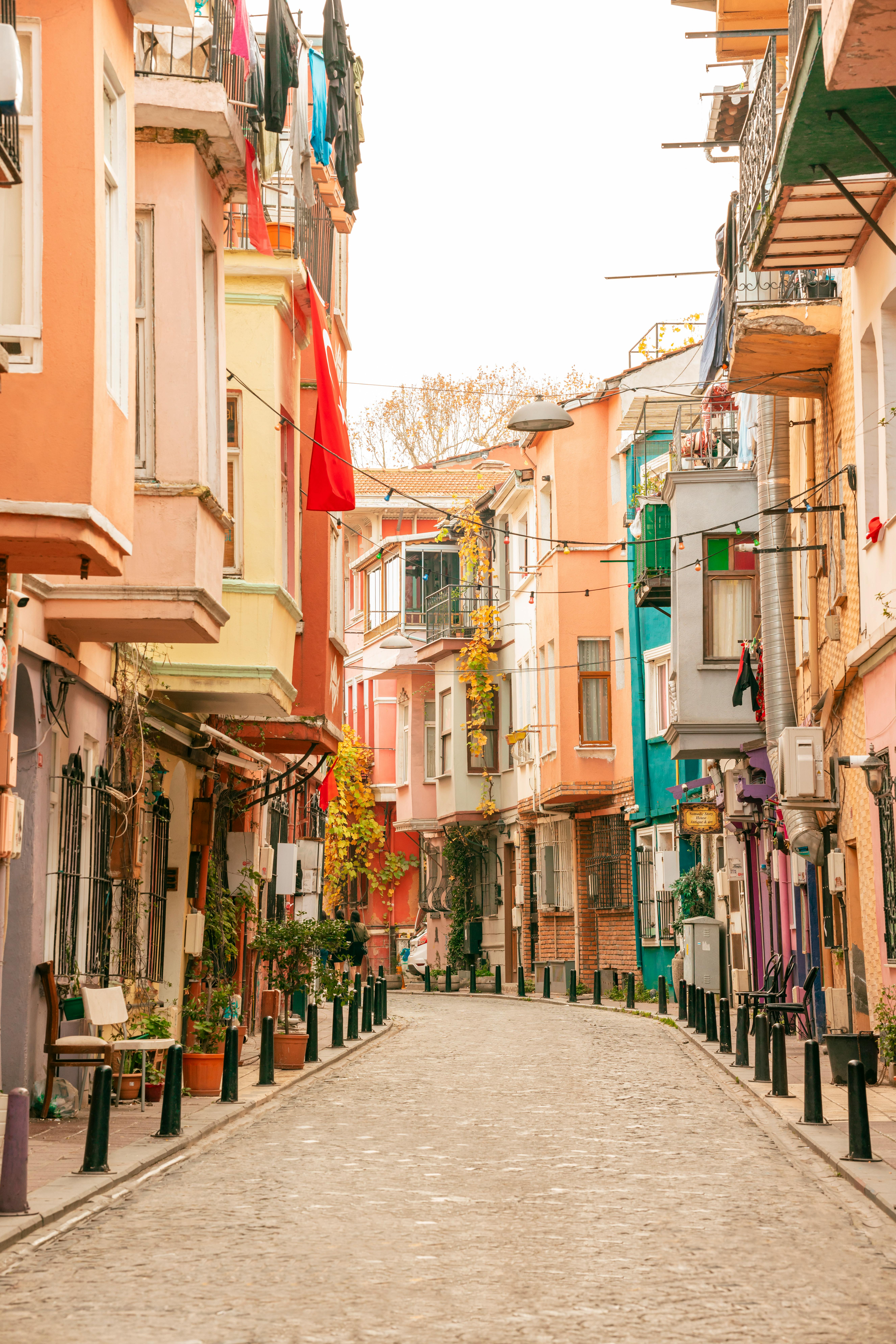 Vibrant alley with colorful townhouses in Türkiye, showcasing unique architectural charm.