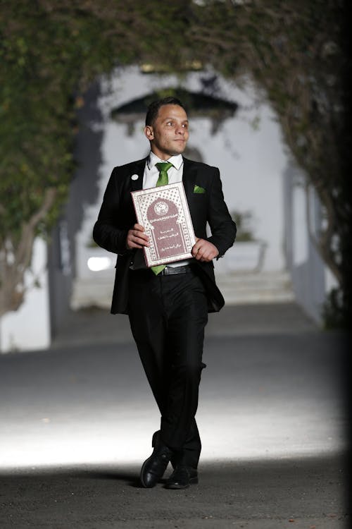 Man in a Suit Holding a Book 