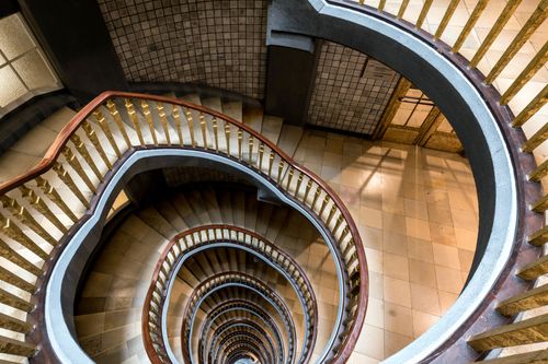 Free An intricate spiral staircase inside a building in Hamburg, Germany, viewed from above. Stock Photo