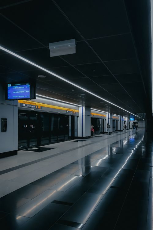 Free A dimly illuminated metro station in Kuala Lumpur, showcasing modern design and urban architecture. Stock Photo