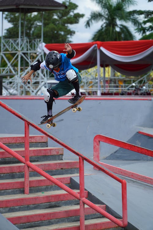 A skateboarder is doing a trick on a rail