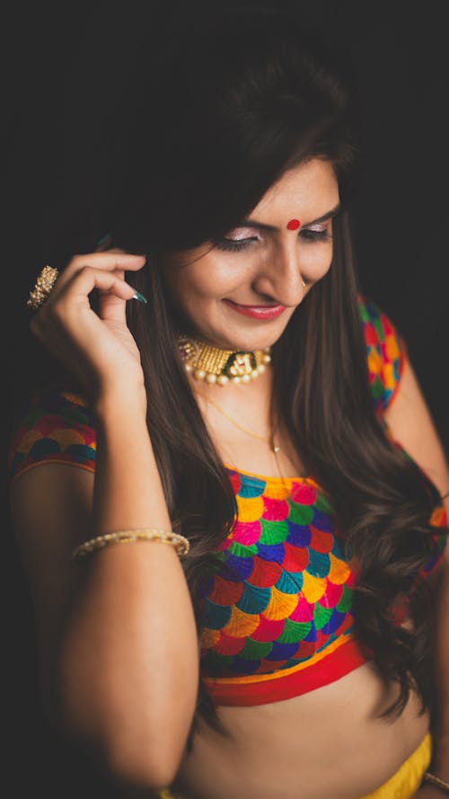 A woman in colorful clothes posing for a photo