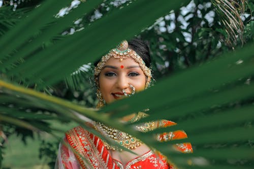 A beautiful indian bride in a traditional red and gold outfit