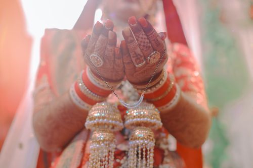 Free Beautiful Indian bride showcasing henna tattoos and traditional jewelry in a close-up shot. Stock Photo