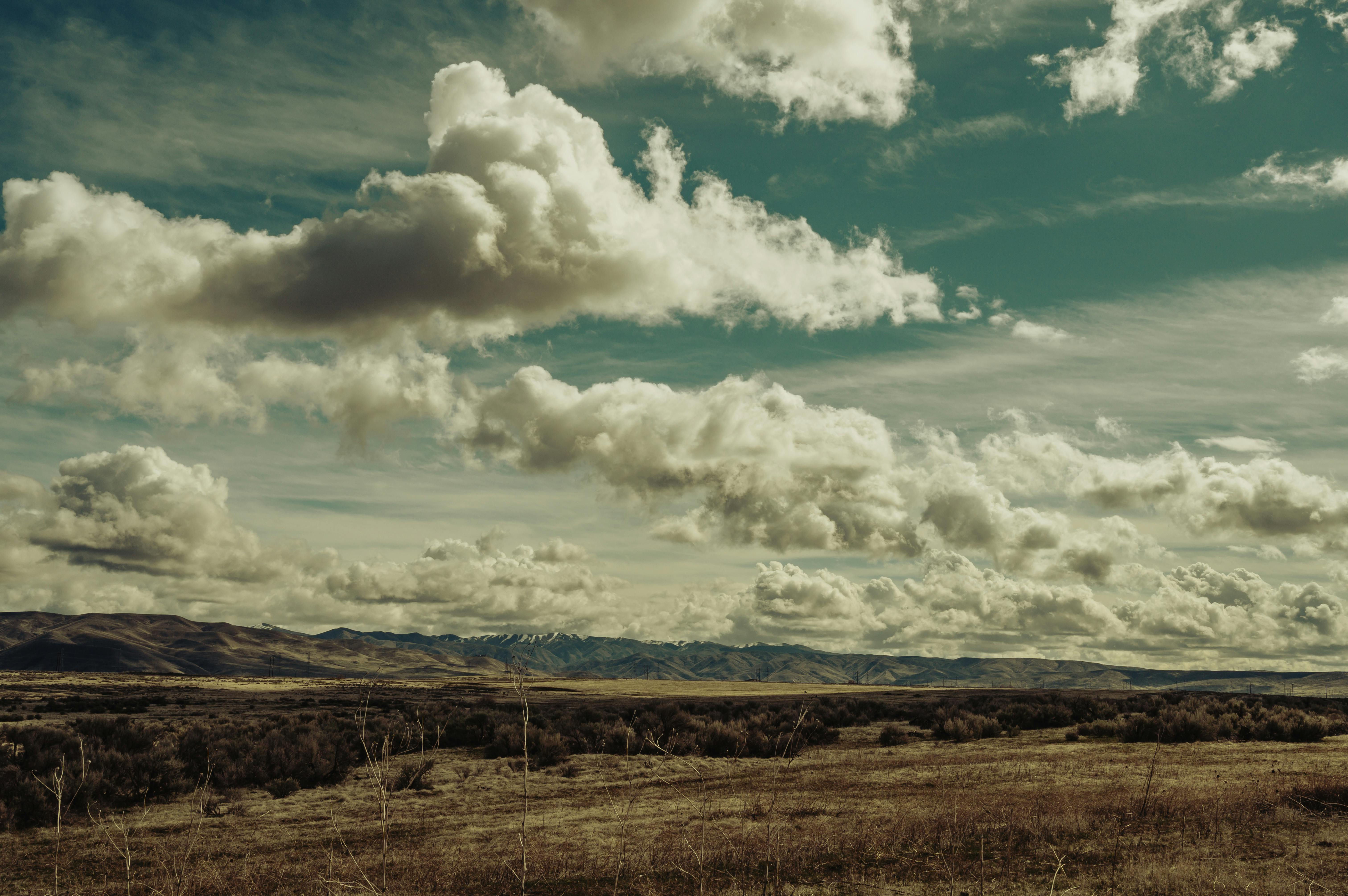 Scenic View Of Mountains Under Cloudy Sky