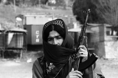 A woman with a gun in her hand