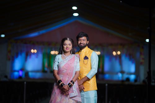 A couple in traditional attire posing for a photo