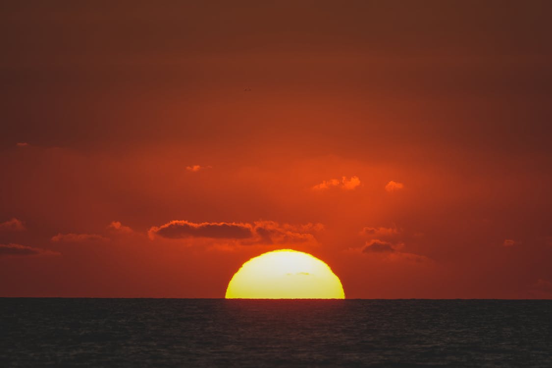 The sun is setting over the ocean in this photo