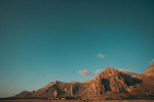 Free A stunning view of rocky hills under a clear blue sky, perfect for nature lovers. Stock Photo