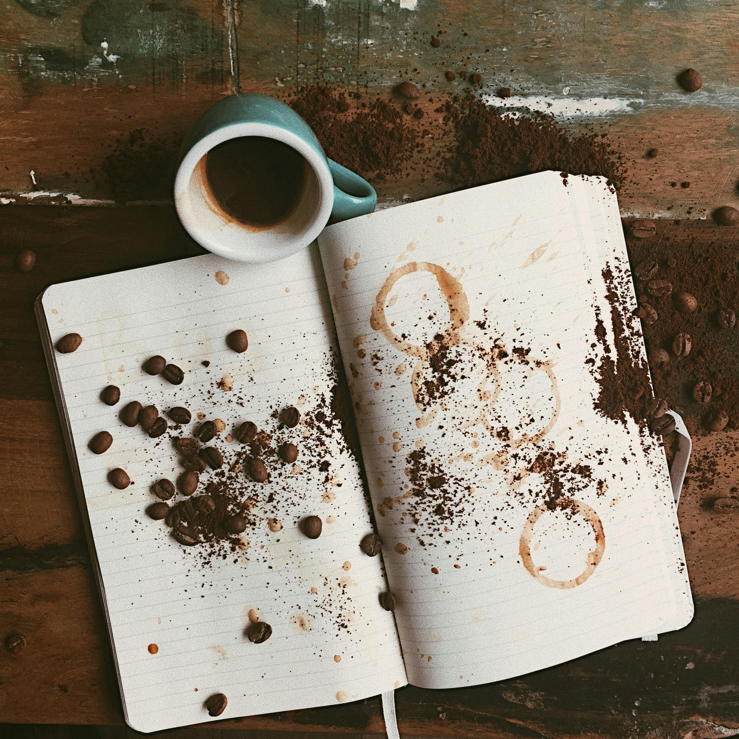 white open book and blue ceramic mug