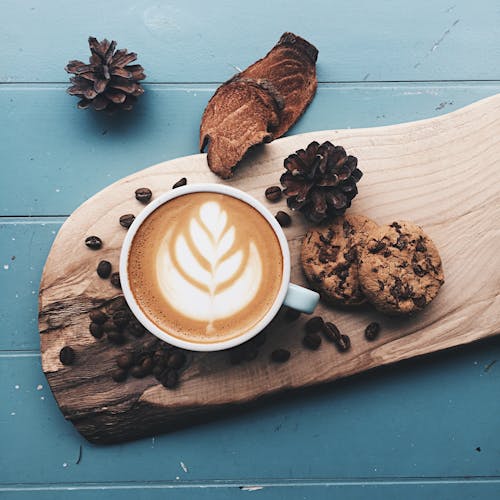 Cup of Coffer on Top of Wooden Board