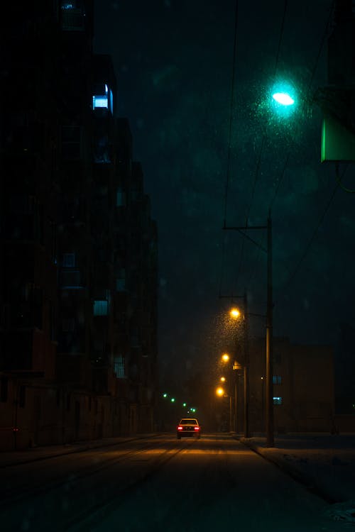 A car driving down a street at night