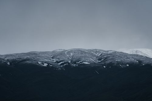 Free Stunning snow-capped mountains under a cloudy sky in Mashhad, Iran. Stock Photo