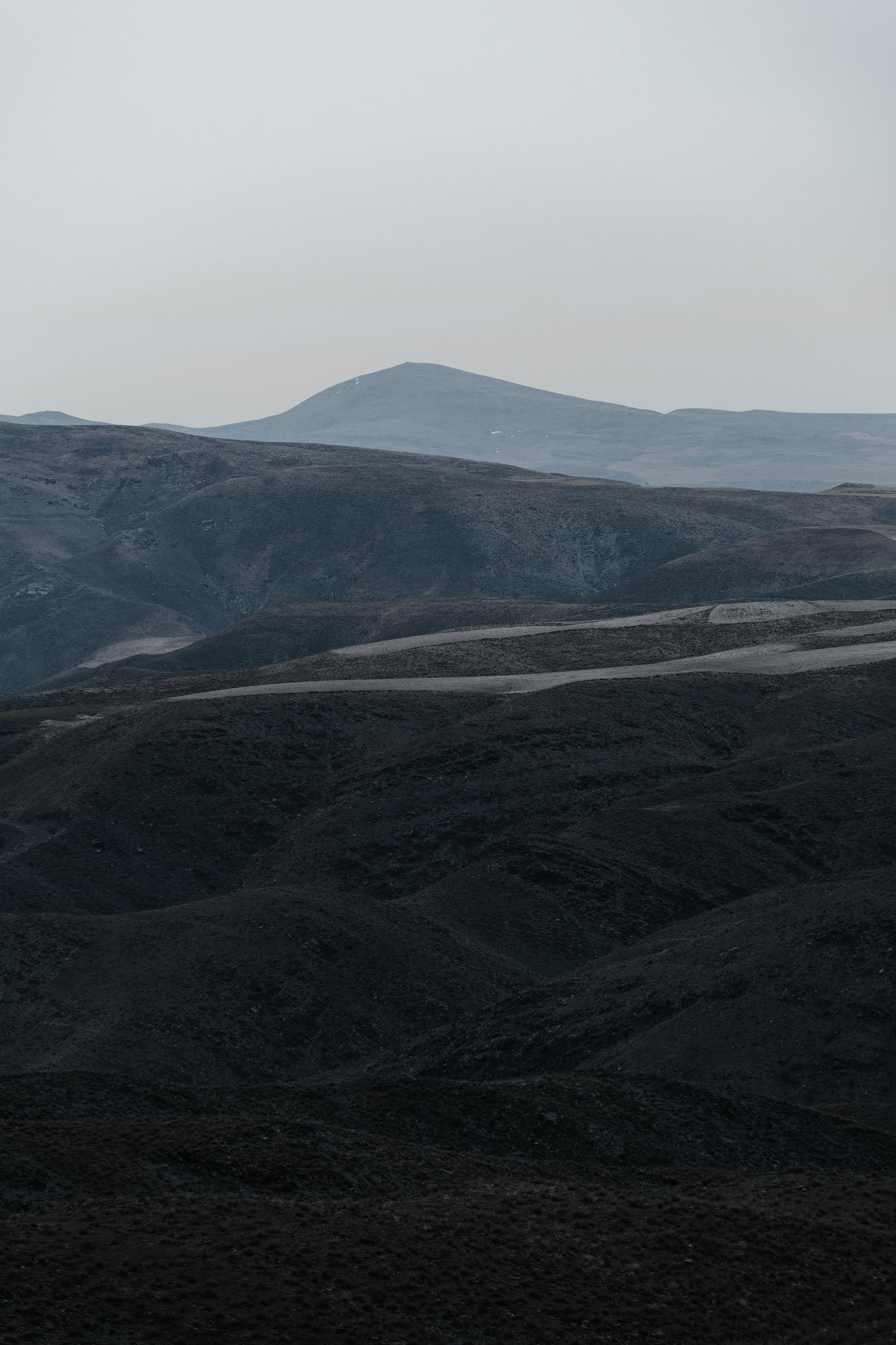Captivating view of Mashhad's rugged mountains at dusk, offering a tranquil natural scene.