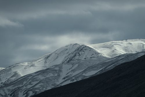 Free Majestic snow-capped mountains under a moody sky in Razavi Khorasan, Iran. Stock Photo