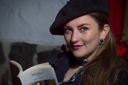 Free A woman in a beret reading a book Stock Photo