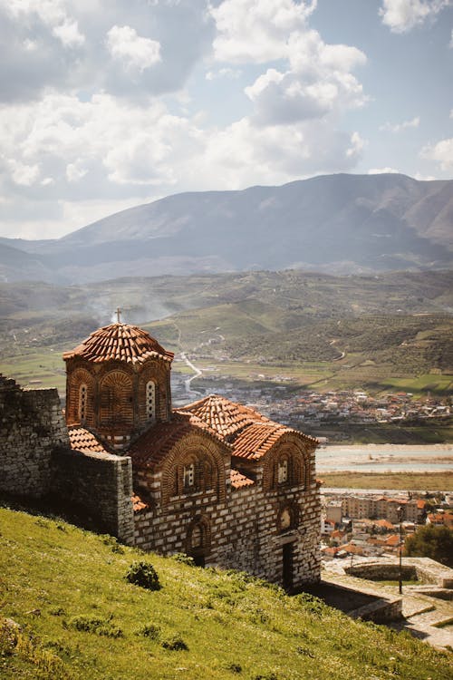 A church sits on top of a hill overlooking a valley