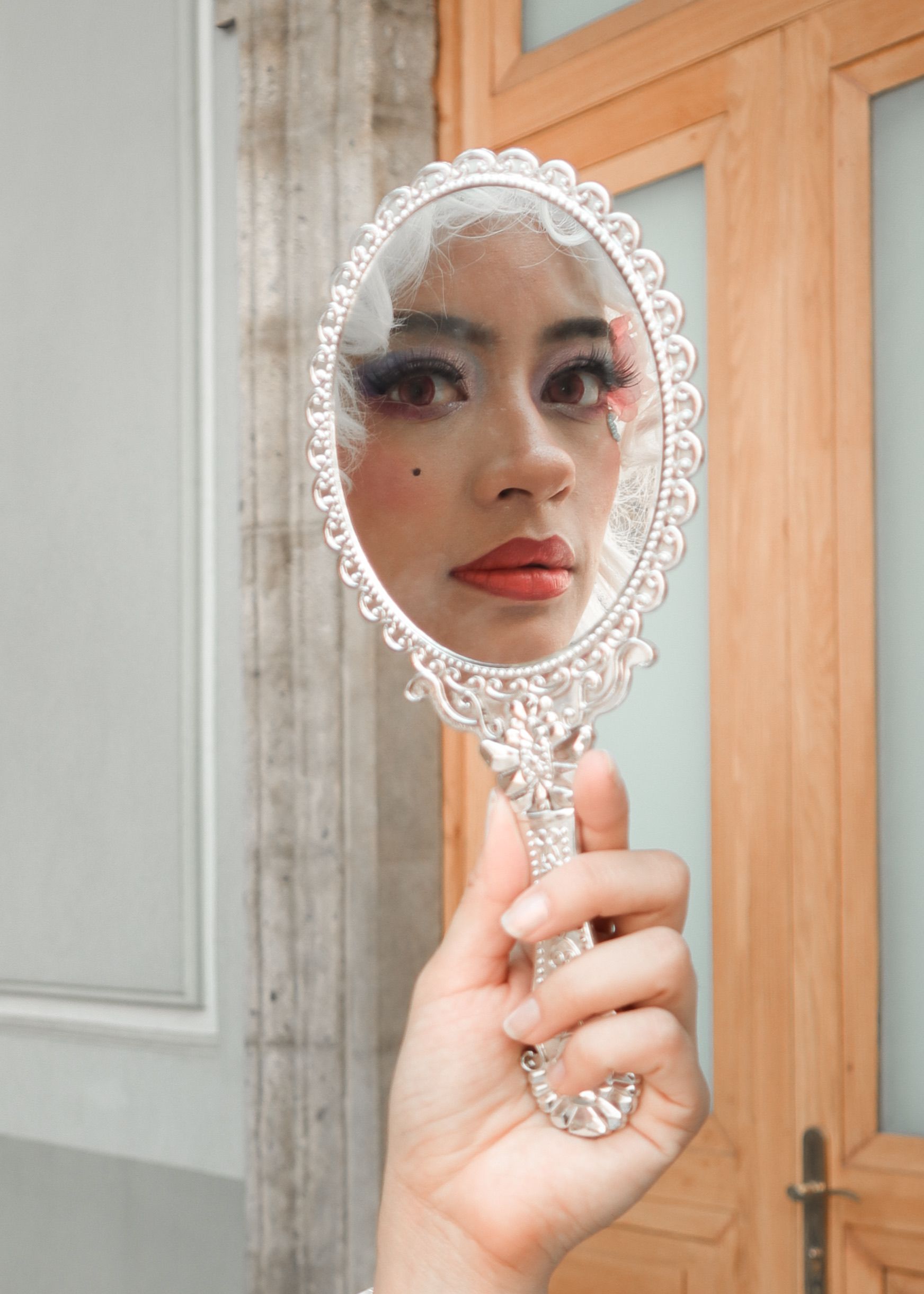 Reflection of a Woman in a Hand Held Mirror · Free Stock Photo