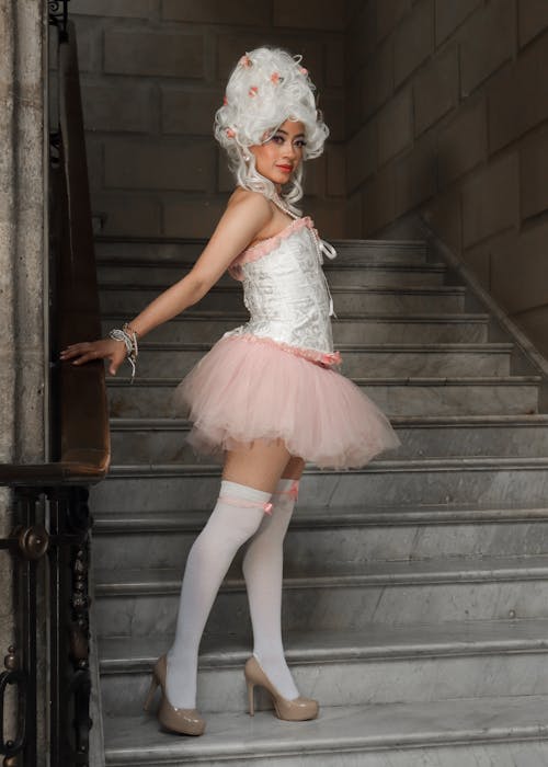 A woman in a pink tutu and white stockings