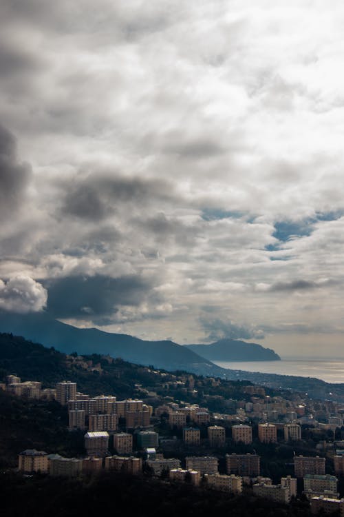 city near the ocean and a mountain