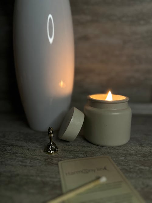 A candle with a match next to it