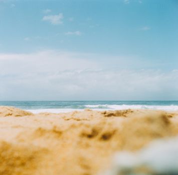 Serene view of Gerringong beach with blue sky and gentle waves, perfect for relaxation.