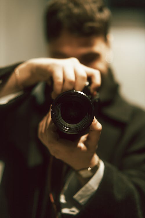 A man taking a picture with a camera