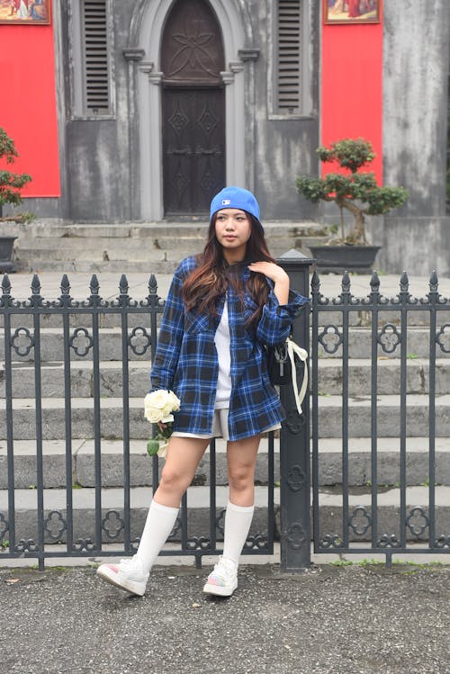 A girl in a plaid shirt and white socks