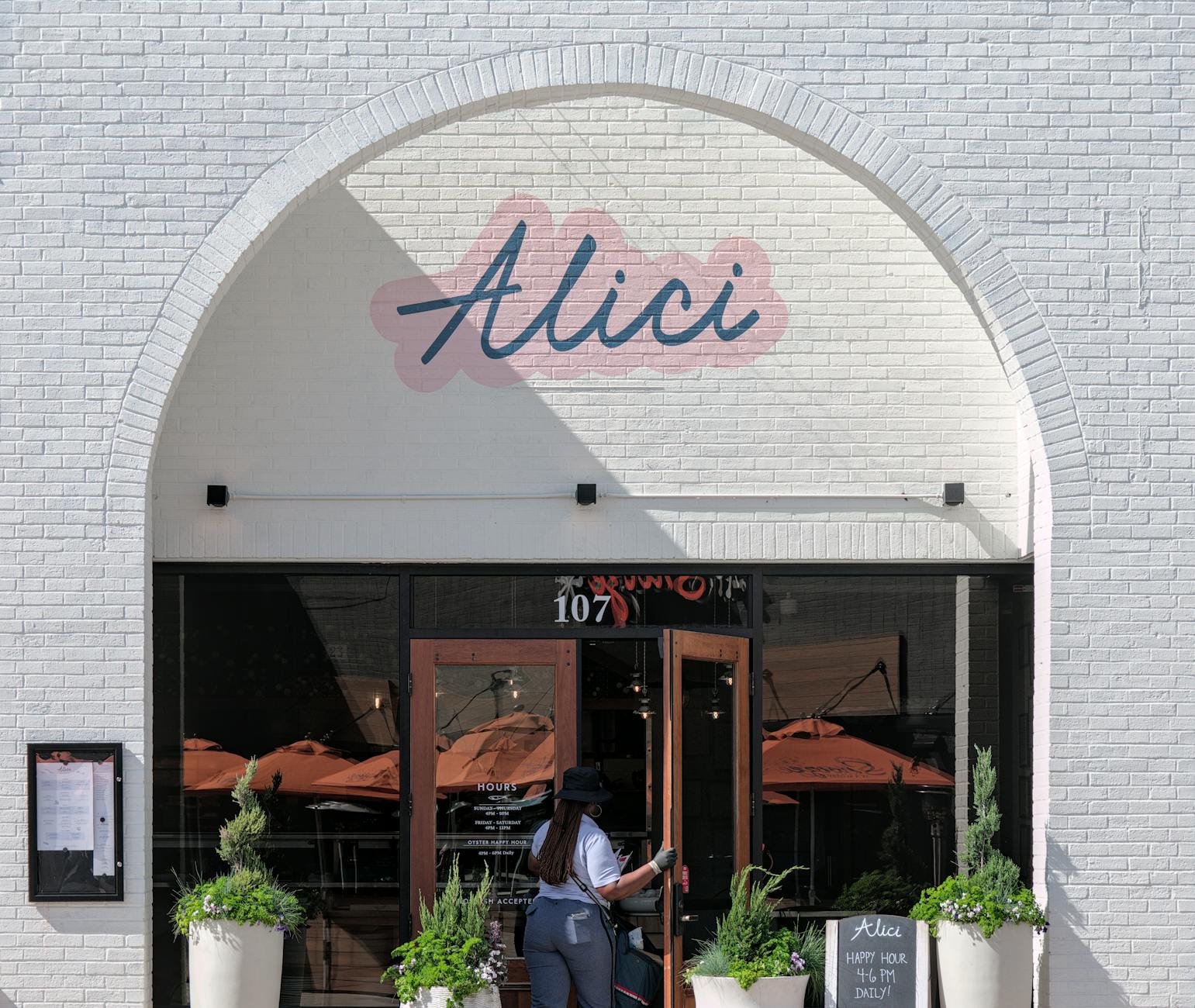 Budget-Friendly Travel: Finding The Best Deals On International Flights 1 elegant restaurant exterior in atlanta featuring entrance with potted plants and signage.