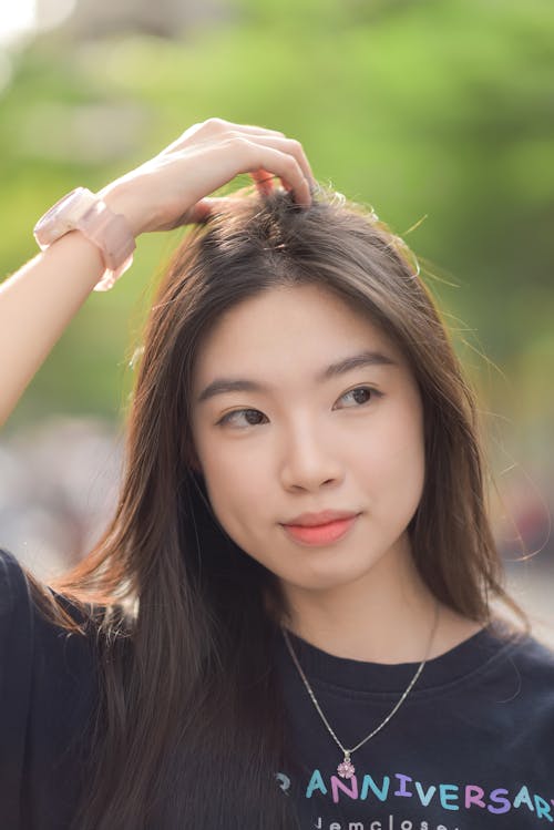 A young woman with long hair and a black shirt