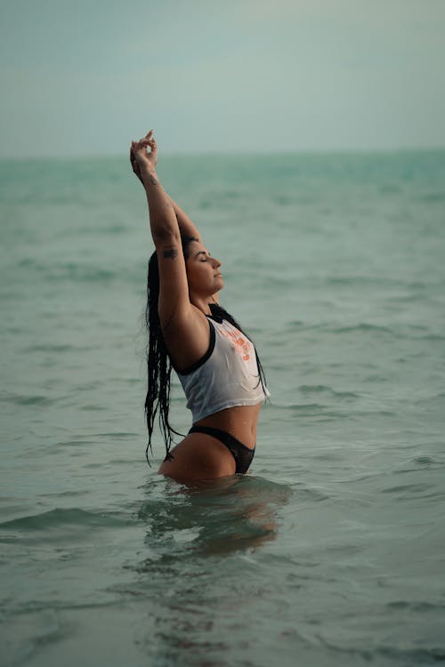 A woman in a bikini is in the water