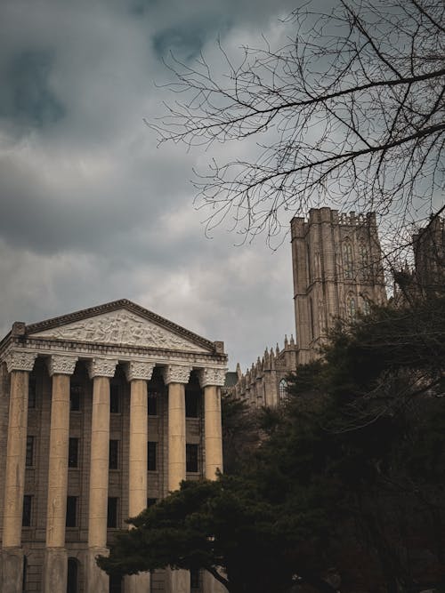 The building is in the background with a cloudy sky