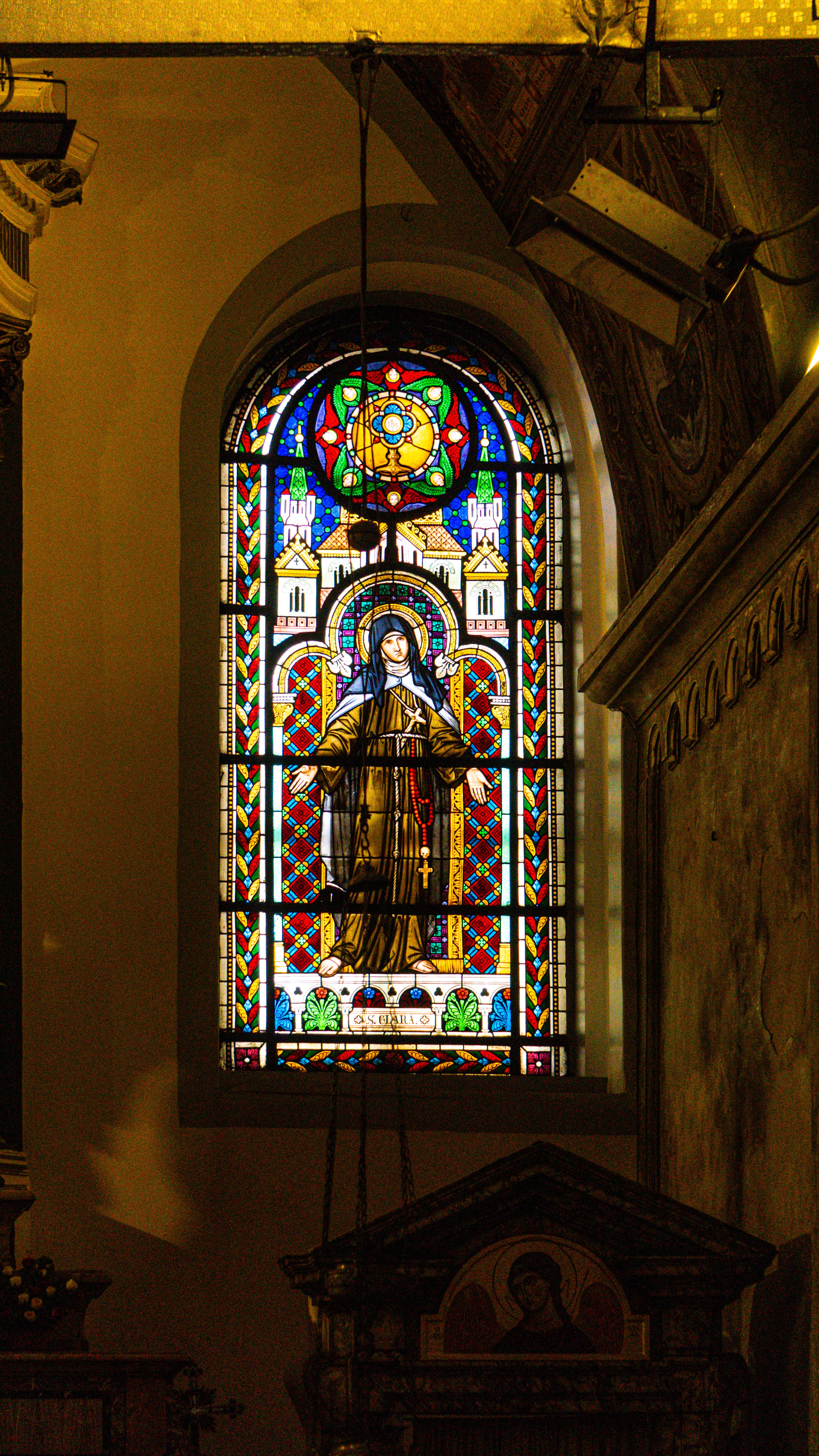 A vibrant stained glass window depicting a religious figure in the historic Saint Maria Draperis Church, Istanbul.