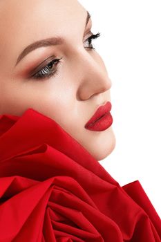 Close-up portrait of a woman with bold makeup and red fabric, showcasing elegance and beauty.
