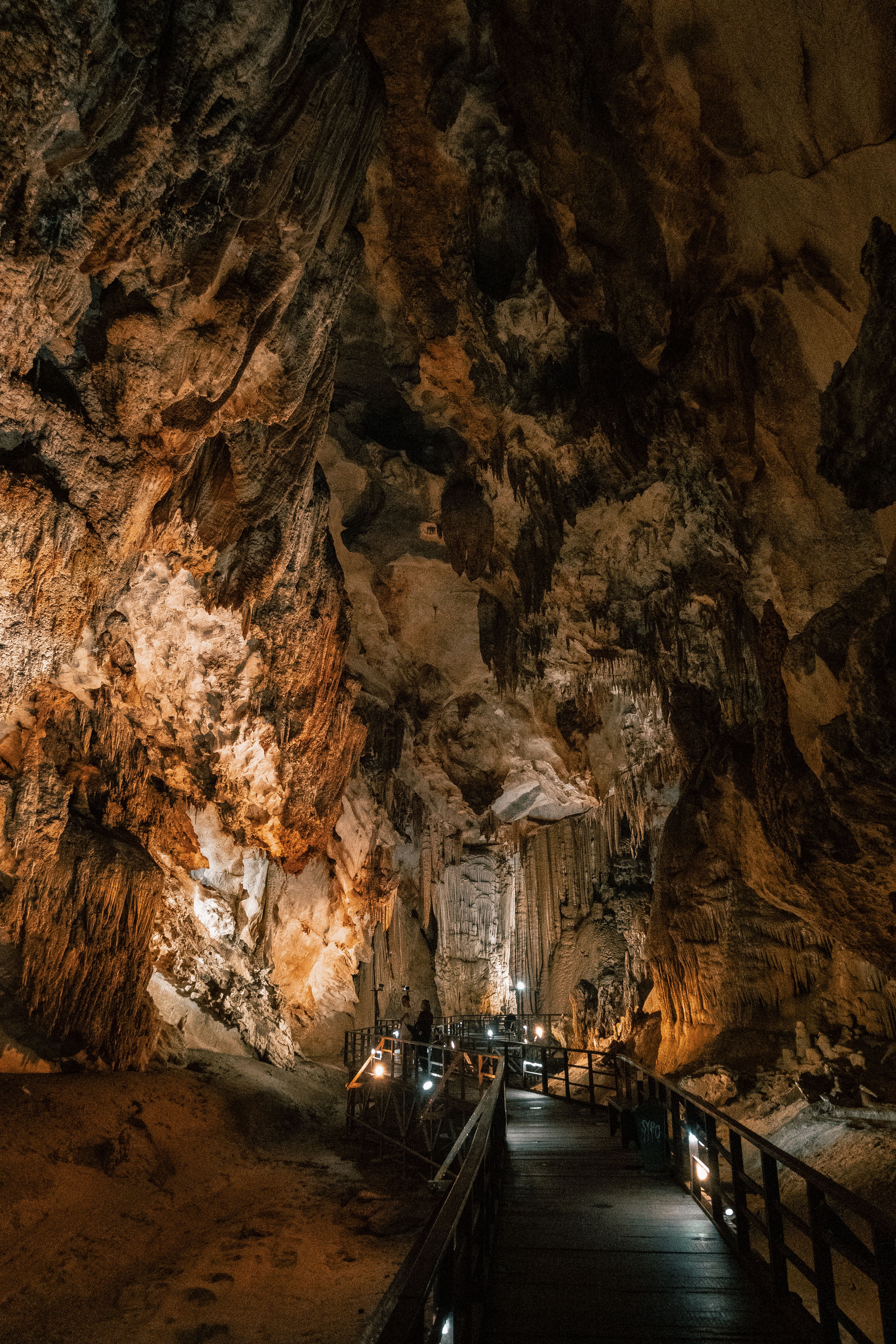 The inside of a cave with a wooden walkway · Free Stock Photo