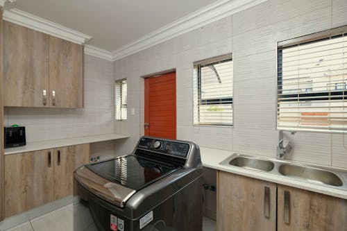 A kitchen with a washer and dryer in it