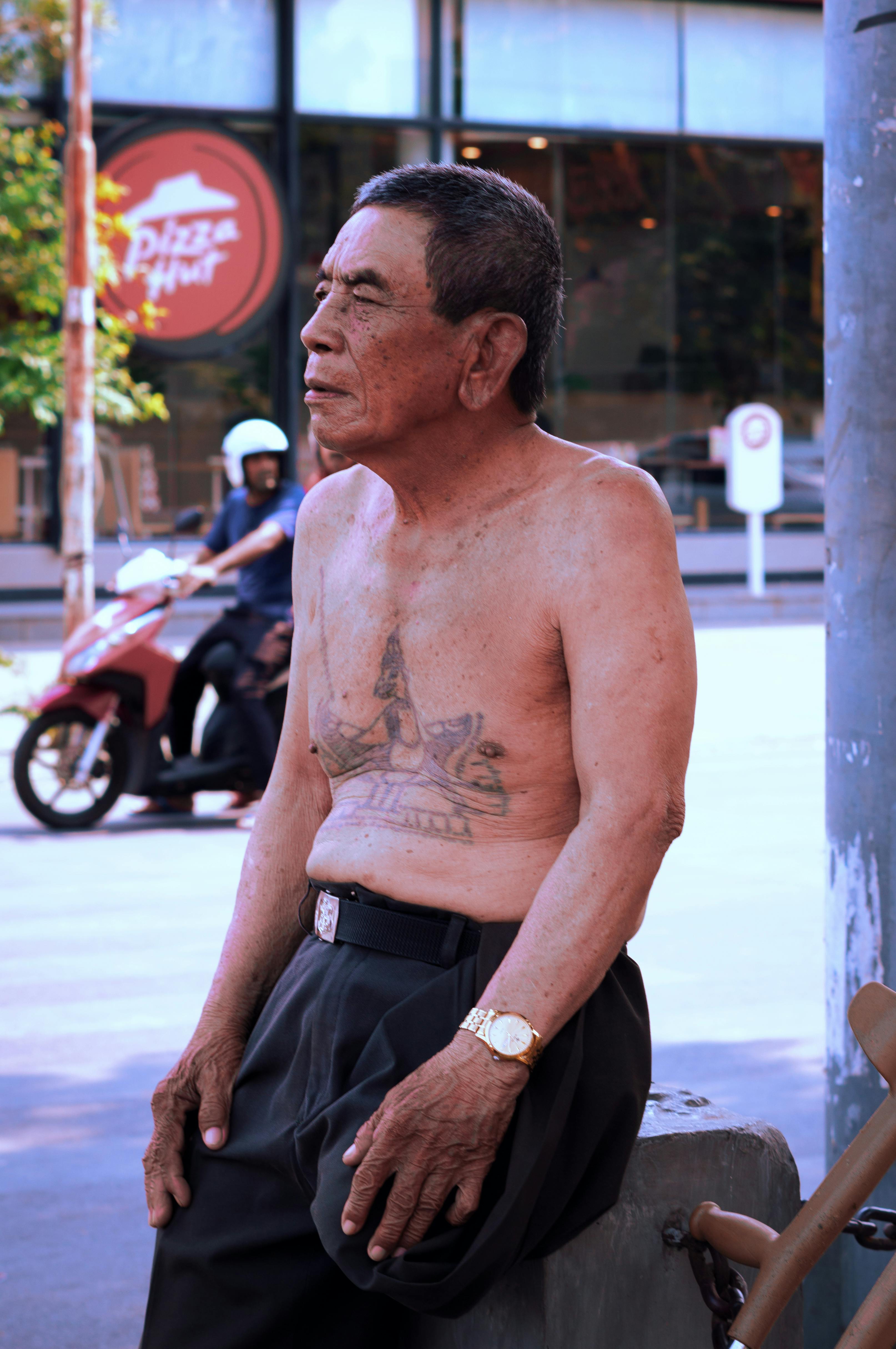 topless man with tattoo