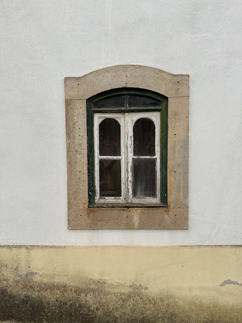 A window with a green and white frame