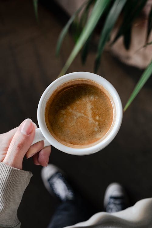 Free Coffee in White Mug in Hand Stock Photo