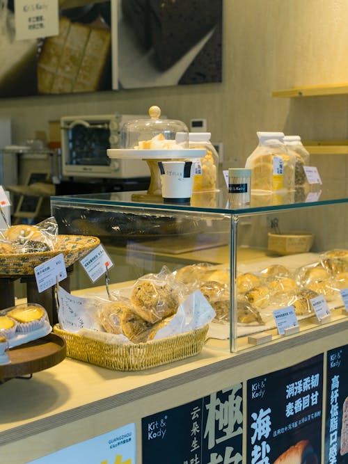 A bakery counter with various types of bread and pastries