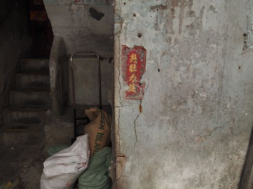Free Aged interior with stairs, sacks, and peeling walls in Hong Kong. Stock Photo