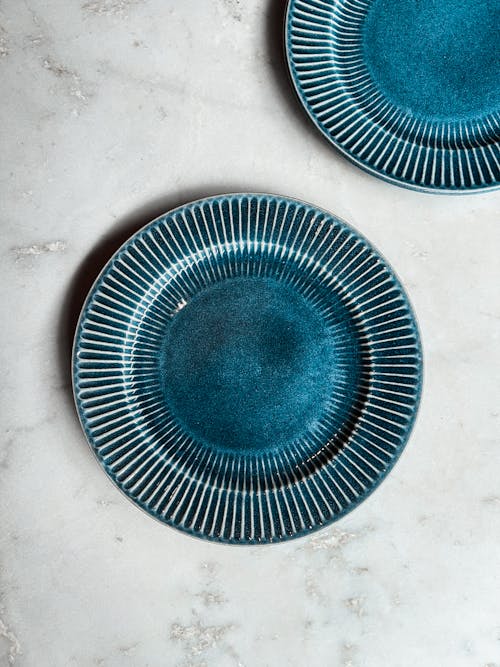 Two blue plates with a stripe design on them