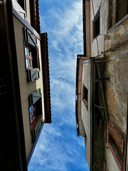 Free Low angle view of urban buildings against a vibrant blue sky, featuring dramatic perspective. Stock Photo
