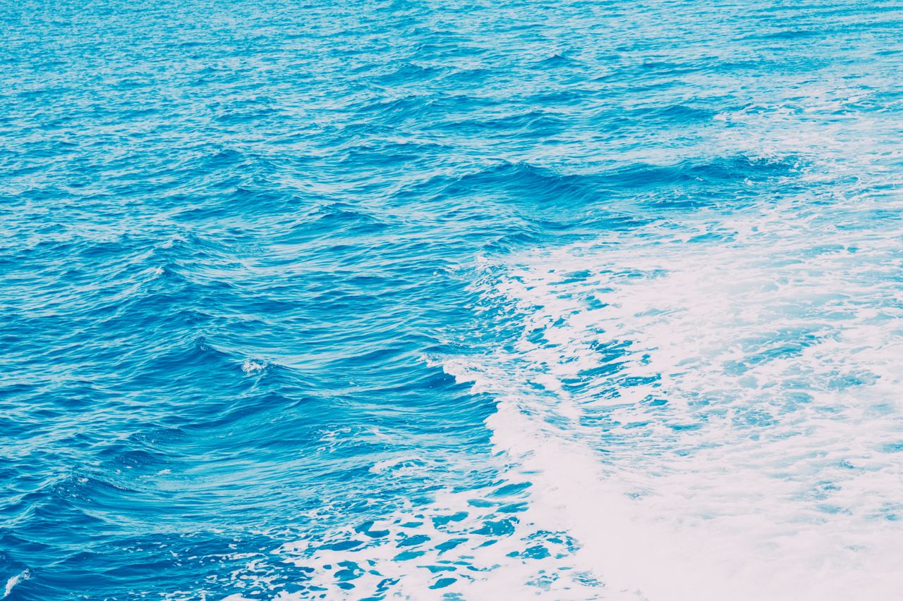 bright blue ocean waves with white ship wake showcasing the sea s dyna